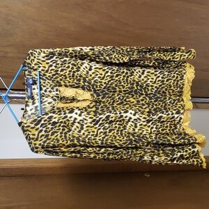 Leopard print rayon blouse with lace keyhole and hem; princess style sleeves.